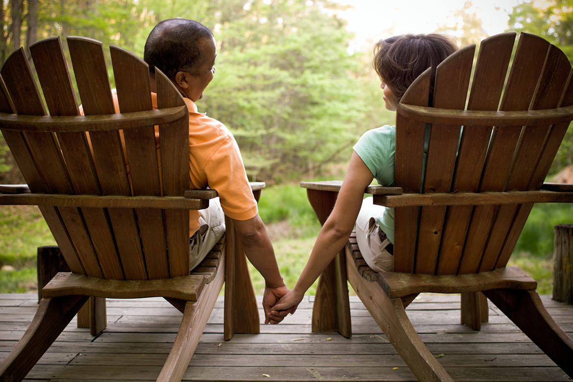 Couple in adirondack chairs enjoying time outdoors