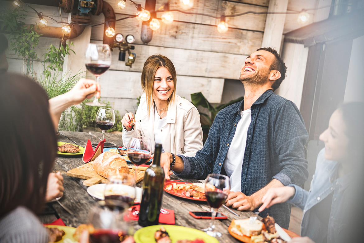 Friends spend time together having dinner outdoors